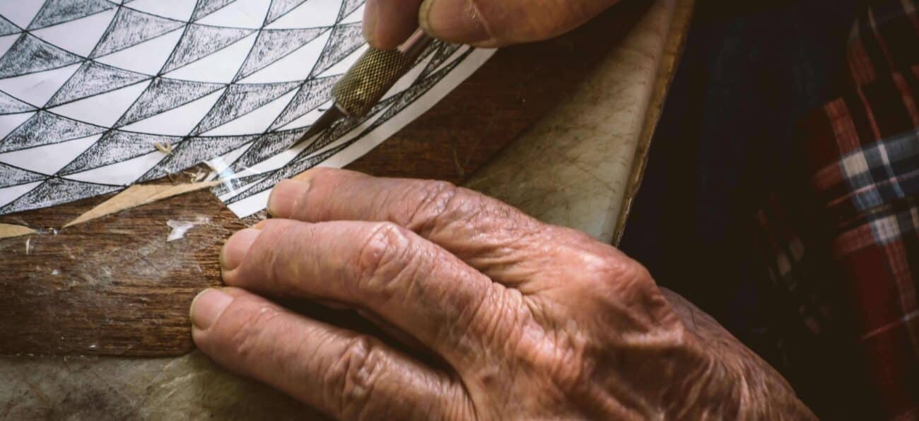 man carving out wood for inlay